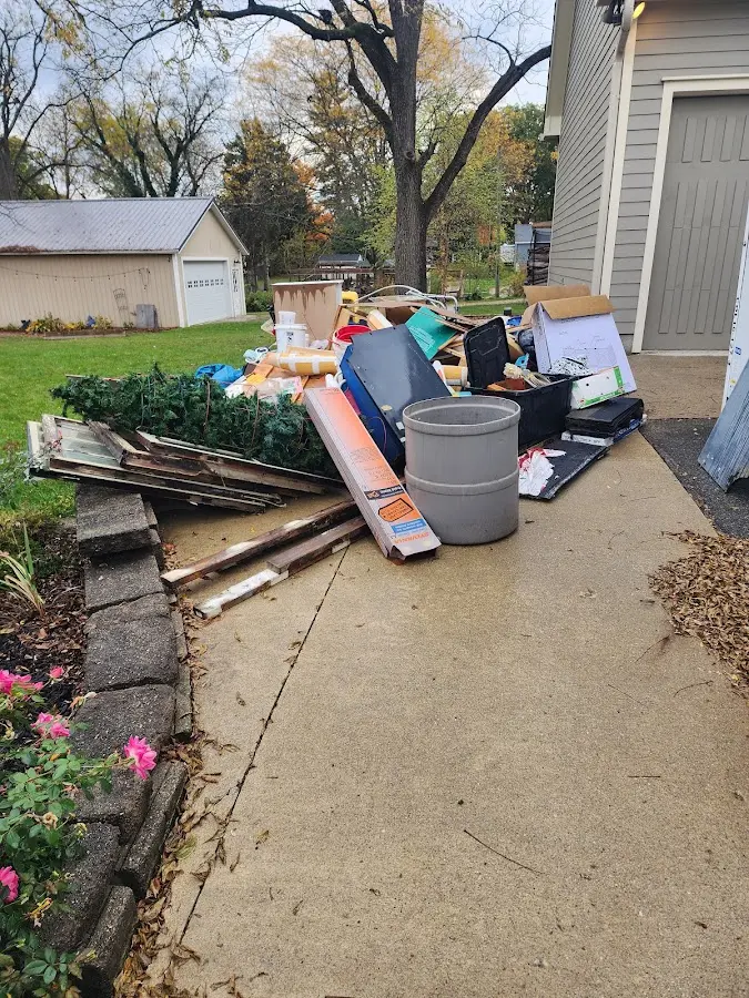 Dumpster being loaded with debris for Estate Cleanout Dumpster Rental in Hutchinson